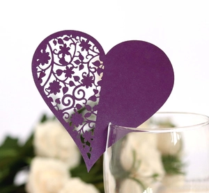 Detail showing deep purple heart-shaped laser-cut wine glass card for wedding decor