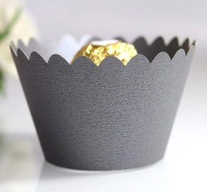Macro shot of dark grey cupcake liner with scalloped edges and a premium matte finish