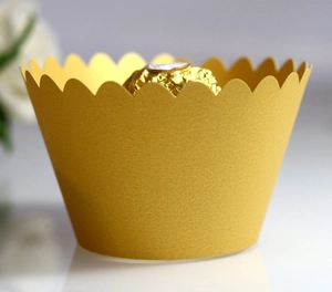 Elegant gold scalloped cupcake liners for party decorations and muffin paper wrappers