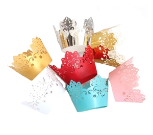 Laser-cut crown lace cupcake wrappers in gold, silver, and pink for wedding cake decoration