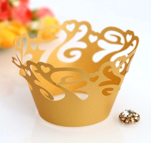 Golden laser-cut cupcake wrappers with heart crown design for wedding celebration