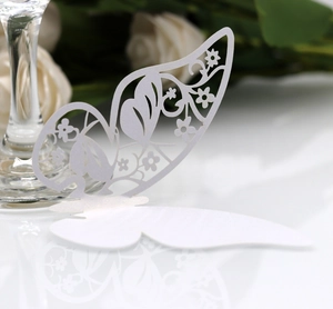 Macro shot of white laser-cut butterfly cup card with elegant floral hollow pattern