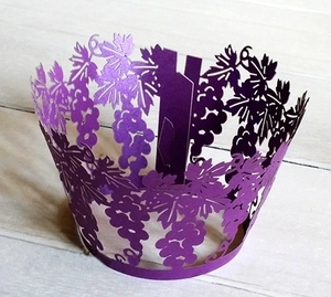 Macro detail of laser-cut grapevine cupcake wrapper in deep purple pearlescent paper