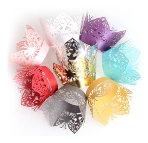 Laser-cut butterfly cupcake wrappers in various colors including pink and gold