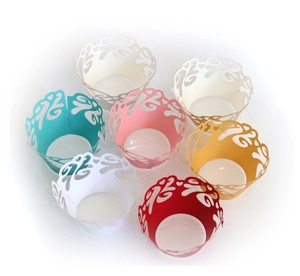 Laser cut lace cupcake wrappers with lucky cloud patterns in various vibrant colors