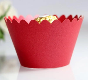 Detail of red wavy edge paper cupcake wrapper with a textured finish for celebrations