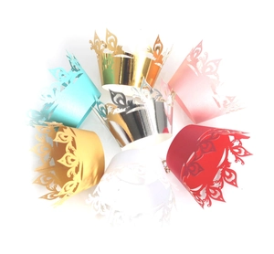 Set of colorful laser-cut crown cupcake wrappers in seven vibrant elegant shades