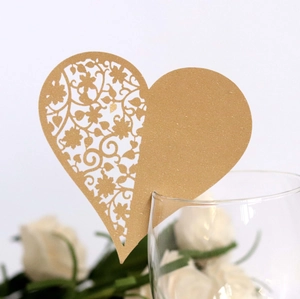 Golden heart-shaped laser cut seat card with floral lace design for wedding glass decor