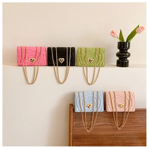 Detailed row of quilted heart chain bags in pink, black, green, blue and beige colors