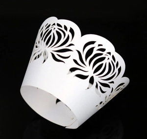Detailed laser-cut white pearlescent paper cupcake wrapper with floral pattern