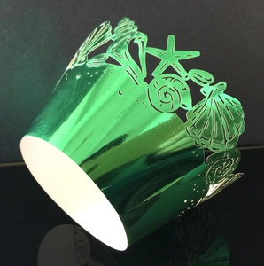Metallic emerald green ocean cupcake wrapper featuring starfish and seashell laser cutouts