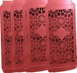 Detail of four red paper envelopes with intricate laser-cut geometric star patterns