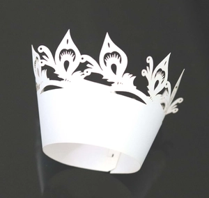 Detailed laser cut white crown cake liner with peacock feather hollow pattern design