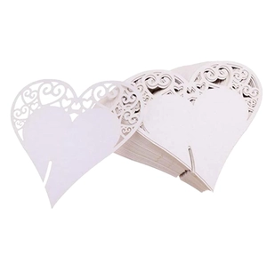 White heart-shaped laser-cut paper cards for wedding party decor and table seat settings