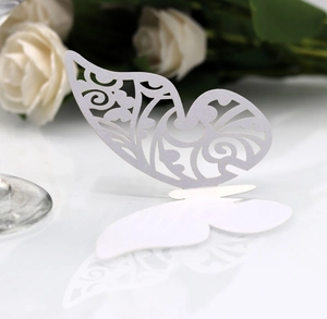 Detail showing white laser-cut butterfly card with intricate floral patterns