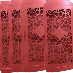 Set of four red laser-cut envelopes with geometric star hollow patterns and a blank center