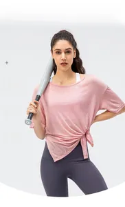 Close-up of pink breathable workout top featuring a decorative side knot detail