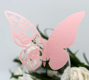 Pink laser-cut butterfly wine glass cards made of pearlescent paper for wedding decor