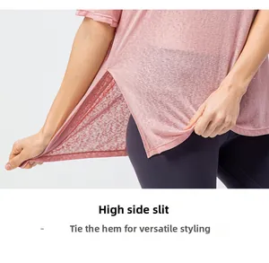 Detail view of pink lightweight mesh t-shirt featuring a functional high side slit design