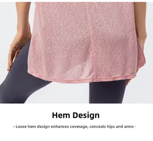 Detail view of the loose curved hem on a pink sports top for hip coverage and breathability