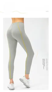 Gros plan du legging de yoga taille haute avec effet push-up et bandes jaunes latérales