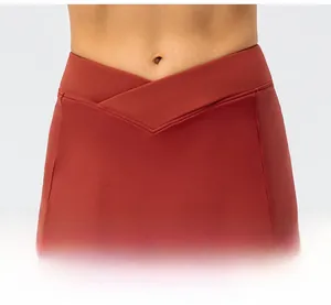 Detail of cross V-shaped high waist design on red athletic skirt with elastic fabric
