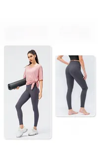 Detail of high-waist grey sports leggings featuring tight fit and contouring seams