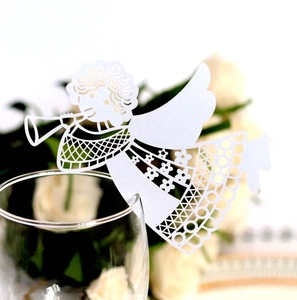 Laser-cut white paper angel place card with intricate patterns for wine glass rims