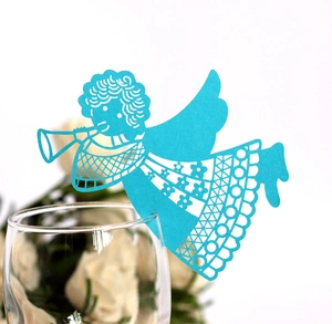 Detail of blue laser-cut angel wine glass card for wedding table party decoration