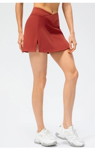Close-up of caramel cross waist tennis skirt with side slit and quick-dry fabric
