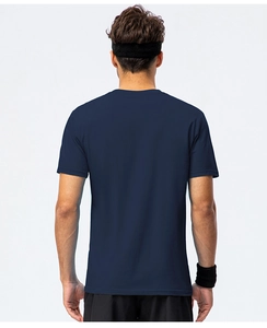 Back view of a man wearing a navy blue cotton crewneck t-shirt with sports accessories