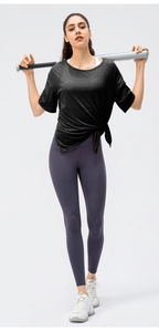 Detail of loose fit quick-dry sports top with breathable texture and side split knot design