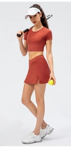 Close-up of brick red tennis skirt with side slit and matching slim-fit short sleeve top