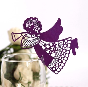Close-up of purple laser-cut angel place cards for wine glass decoration