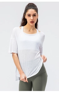 Detail of white breathable mesh T-shirt and olive green high-waist yoga pants on model