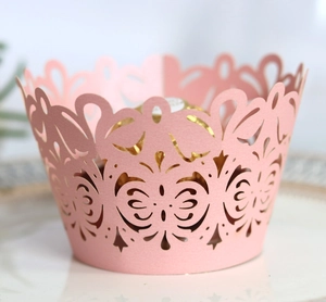 Detailed laser-cut butterfly and floral pattern on a pink paper cupcake wrapper