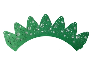 Detail of green laser-cut Christmas tree cupcake wrappers with intricate snowflake patterns