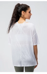 Detail of white breathable mesh yoga top showing sheer fabric and racerback design