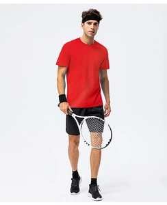 Action shot of a men's loose fit red cotton t-shirt for sports with tennis racket