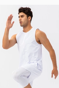 Men's white quick-dry fitness tank top showing side slit detail during running motion