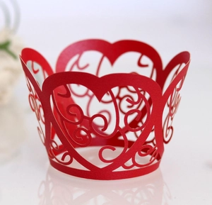 Detailed laser-cut heart pattern cupcake wrappers in red for wedding decorations