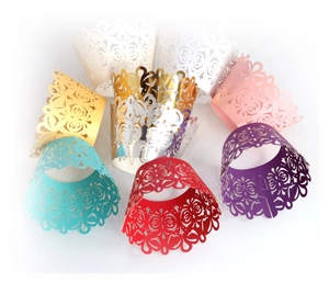 Laser-cut pearlescent cupcake wrappers with hollow floral patterns in various colors