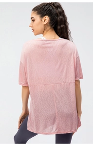 Back view of a pink loose sports shirt featuring stylish split hem and breathable fabric