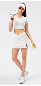 Detail of high-waist white tennis skirt with V-cross waistband and side slit design