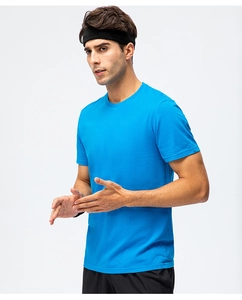 Detail of royal blue cotton T-shirt showing crew neck fit on model with athletic shorts