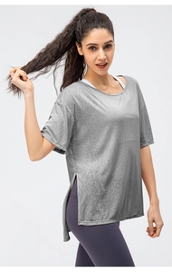 Detail view of grey quick-dry workout top featuring a side slit for yoga and running