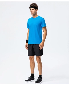 Full view of royal blue cotton t-shirt paired with black athletic shorts and sports gear