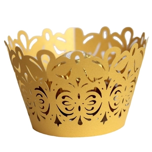 Golden laser-cut cupcake wrappers with elegant floral patterns for wedding party decor