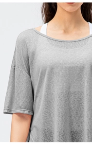 Close-up of loose-fit grey sports top featuring drop shoulder design and knit texture