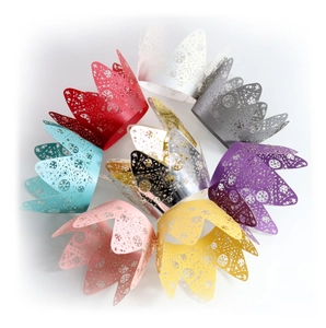Detailed laser-cut snowflake crown cupcake wrappers in multiple vibrant colors for party décor